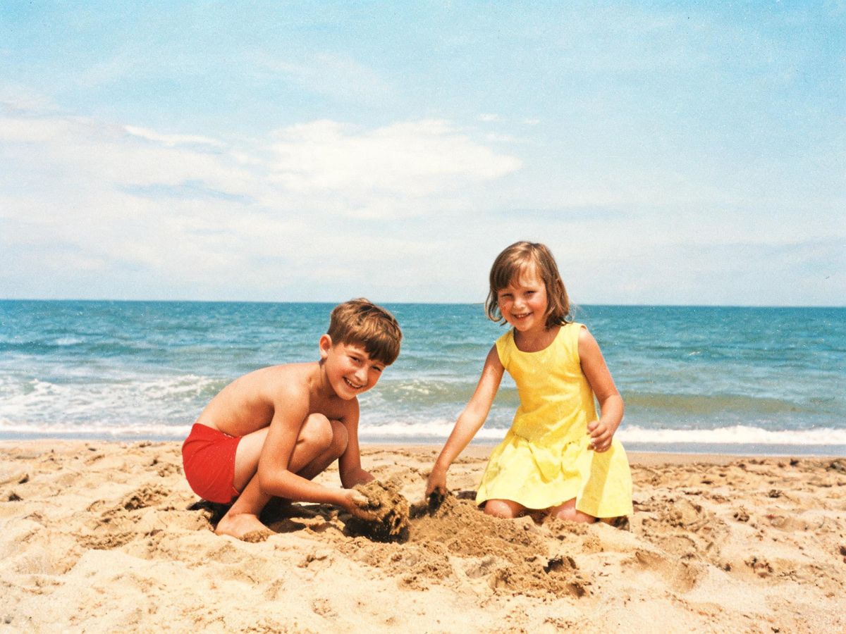 Children playing on the beach, 1960s — colorized